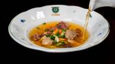 Beef broth with liver dumplings, celestine noodles and vegetables